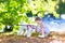 Adorable baby girl with pudel dog on river shore