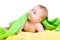 Adorable baby in green towel looking up