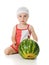 An adorable baby happily plays the watermelon