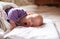 Adorable baby lying in crib waking up and yawning