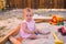 Adorable baby play with sand in sandbox on playground, summer childhood
