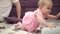 Adorable baby playing with father. Infant crawling to mom. Toddler girl crawl