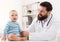 Adorable baby sitting with doctor at clinic