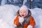 Adorable baby try to eat cold snow