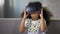 Adorable black girl wearing virtual reality glasses and playing game, resting