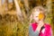 Adorable blond girl in autumn nature