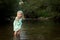 Adorable blond girl playing in river, exploration concept