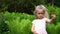 Adorable blond kid hold red ripe cherries berries fruits and show finger. Gimbal