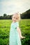 Adorable blond little girl with cheeky smile, outdoors