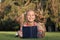 Adorable bookworm. Schoolgirl reading stories relaxing green lawn. Cute pupil enjoy reading. School time. Developing