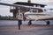 Adorable boy in aviation hat running at aerodrome