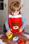 Adorable boy baking ginger bread cookies for Christmas