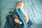 Adorable boy in the bedroom. A newborn baby is resting in a blue-colored bed.