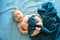Adorable boy in the bedroom. A newborn baby is resting in a blue-colored bed.