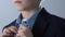 Adorable boy buttoning up blue shirt, getting ready for school, child fashion