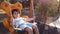 Adorable boy, preschooler swinging on the swing in an empty park