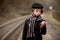 Adorable boy on a railway station, waiting for the train with suitcase