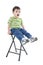 Adorable Boy Sitting On Stool With Upset Expression