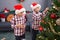 Adorable boys decorating christmas tree at home