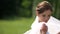 Adorable bride with dark hair and pretty smile is spinning round and playing with her perfect white veil.