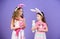 Adorable bunny girls. Little children wearing Easter bunny ears. Cute children in Easter bunny style holding hearts