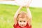 Adorable Caucasian kid playing with scoop-net on the meadow on warm and sunny summer or spring day.