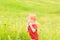 Adorable Caucasian kid playing with scoop-net on the meadow on warm and sunny summer or spring day.