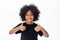 Adorable and cheerful African American kid with afro hairstyle giving thumbs up