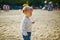 Adorable cheerful toddler girl with pigtails on playground