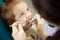 Adorable child calmly goes through procedure of teeth polishing