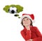 Adorable child with Christmas hat thinking with a soccer ball