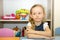 Adorable child girl draws a brush and paints in nursery room. Kid in kindergarten in Montessori preschool class.