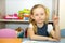 Adorable child girl draws a brush and paints in nursery room. Kid in kindergarten in Montessori preschool class.