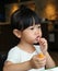 Adorable child girl eating Deep-fried Cheese Stick