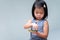 Adorable child girl holding green leaves on her hands. Kid learning the characteristics of leaves and nature