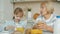 Adorable child having healthy breakfast at home while granny talking smiling