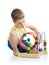 Adorable child playing with toy. Kid having fun with colorful toy on white.