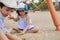 Adorable children, boy and girl, playing on the sandy playground on the beach. Childhood and summer holidays concepts. Summer camp