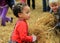 Adorable children having fun while they play in haystacks,Bunratty Castle,Ireland,2014