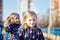 Adorable childs in blue jaket posing outdoors. Girls having fun together