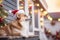 Adorable corgi dog in festive Christmas costume on the snowy porch of a house.