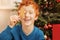 Adorable curly haired child playing with gingerbread man