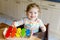 Adorable cute beautiful little baby girl playing with educational wooden music toys at home or nursery