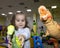 Adorable Cute Beautiful Little Girl Playing with Dinosaurs. Closeup Girl Scares with Toys