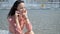 Adorable, cute brunette woman, sitting next to city fountain in the summer