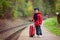 Adorable cute little child, boy, waiting on a railway station fo