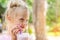 Adorable cute preschooler caucasian blond girl portrait sipping fresh tasty strawberry milkshake coctail at cafe outdoors.