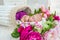 Adorable cute sweet sleeping baby girl in white basket with flowers on wooden floor