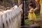 Adorable cute toddler girl with mother feeding little sheeps on a kids farm. Beautiful baby child petting animals in the
