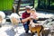 Adorable cute toddler girl and young father feeding little goats and sheeps on a kids farm. Beautiful baby child petting